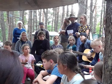Two Monastic Fathers Sing at Campfire